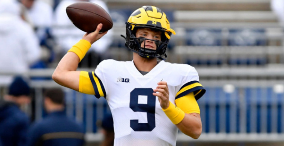 Michigan Wolverines quarterback J.J. McCarthy attempts a pass during a college football game in the Big Ten.