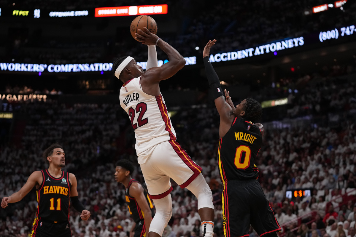 Apr 19, 2022; Miami, Florida, USA; Miami Heat forward Jimmy Butler (22) puts up a shot over Atlanta Hawks guard Delon Wright (0) during the first half in game two of the first round for the 2022 NBA playoffs at FTX Arena.