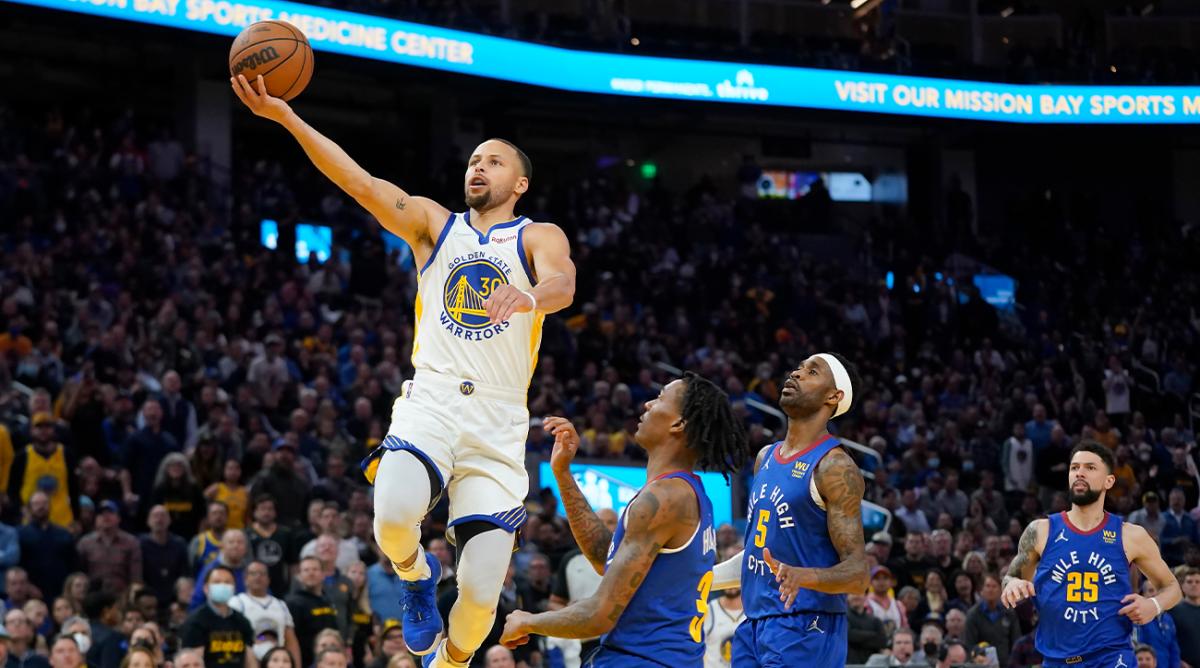 Golden State Warriors guard Stephen Curry (30) shoots against Denver Nuggets guard Bones Hyland, bottom, and forward Will Barton (5) during the second half of Game 2 of an NBA basketball first-round playoff series in San Francisco, Monday, April 18, 2022.
