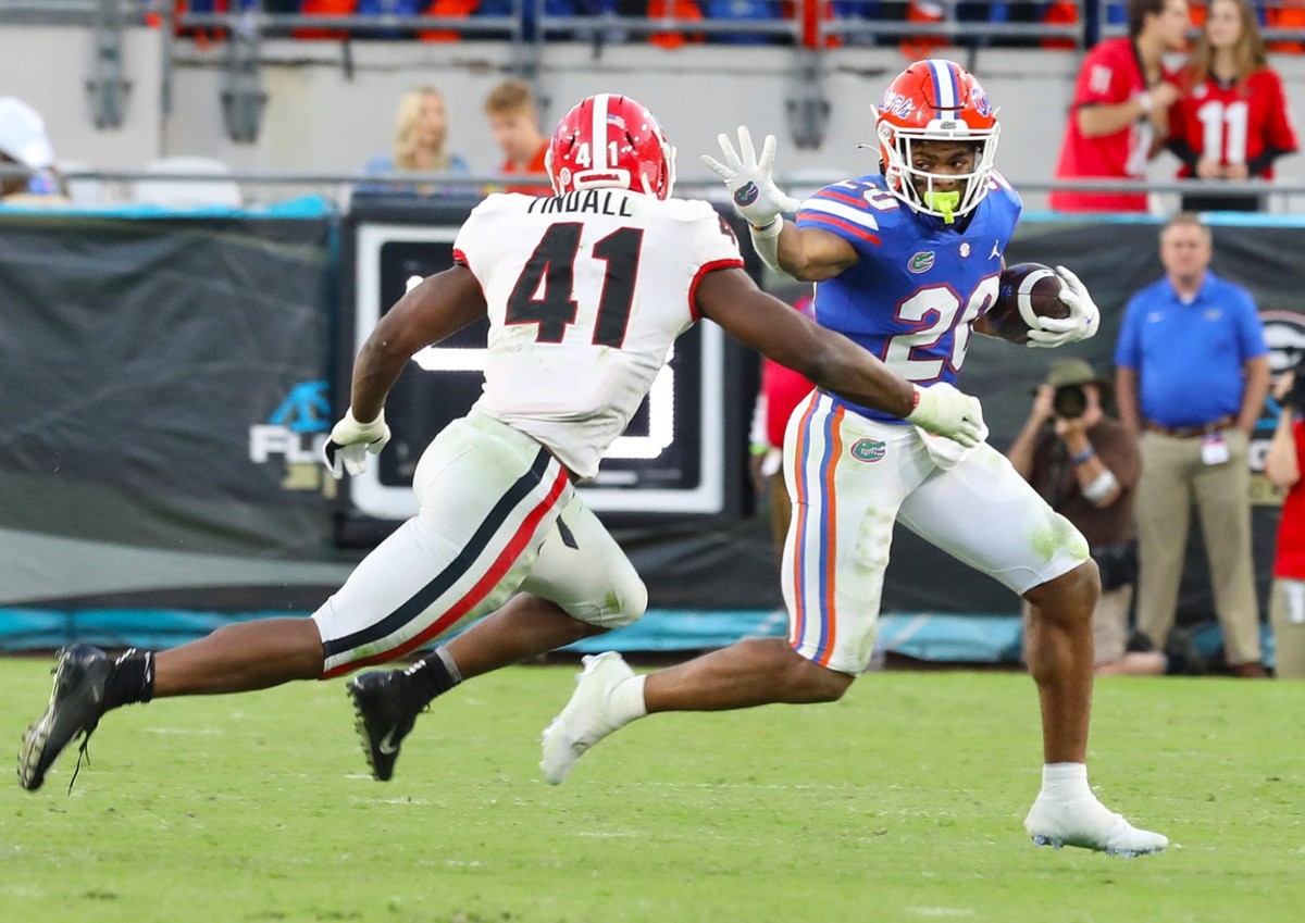 Florida running back Malik Davis (20) tries to avoid Georgia Bulldogs linebacker Channing Tindall (41). Brad McClenny/The Gainesville Sun / USA TODAY NETWORK