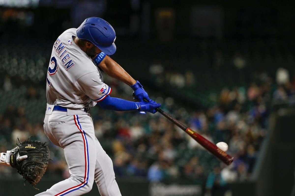 Apr 19, 2022; Seattle, Washington, USA; Texas Rangers second baseman Marcus Semien (2) hits an RBI-double against the Seattle Mariners during the fifth inning at T-Mobile Park. Mandatory Credit: Joe Nicholson-USA TODAY Sports