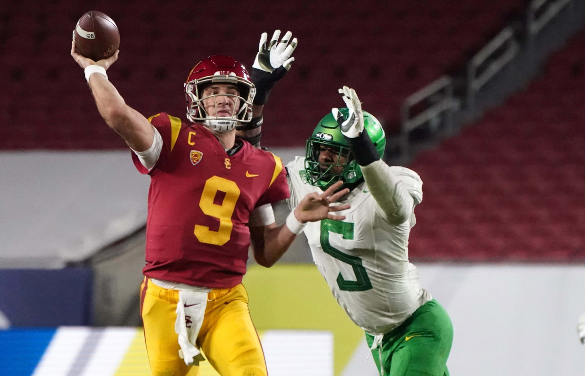 Dec 18, 2020; Los Angeles, California, USA; Southern California Trojans quarterback Kedon Slovis (9) throws the ball under pressure from Oregon Ducks defensive end Kayvon Thibodeaux (5) in the second quarter during the Pac-12 Championship at United Airlines Field at Los Angeles Memorial Coliseum. Mandatory Credit: Kirby Lee-USA TODAY Sports