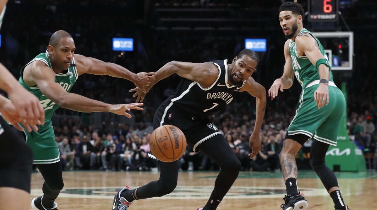 Brooklyn Nets’ Kevin Durant, center, vies for the ball with Boston Celtics’ Al Horford (42) and Jayson Tatum (0) during the first half of Game 2 of an NBA basketball first-round Eastern Conference playoff series, Wednesday, April 20, 2022, in Boston.