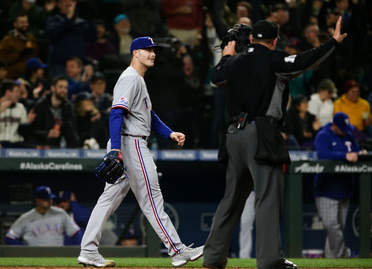 Apr 20, 2022; Seattle, Washington, USA; Texas Rangers relief pitcher John King (32) reacts after giving up three runs to the Seattle Mariners during the fifth inning at T-Mobile Park. Mandatory Credit: Lindsey Wasson-USA TODAY Sports