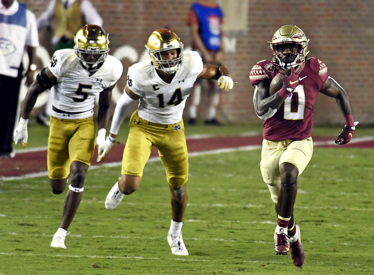 Sep 5, 2021; Tallahassee, Florida, USA; Florida State Seminoles running back Jashaun Corbin (0) runs for a touchdown past Notre Dame Fighting Irish safety Kyle Hamilton (14) and cornerback Cam Hart (5) during the first quarter at Doak S. Campbell Stadium. Mandatory Credit: Melina Myers-USA TODAY Sports