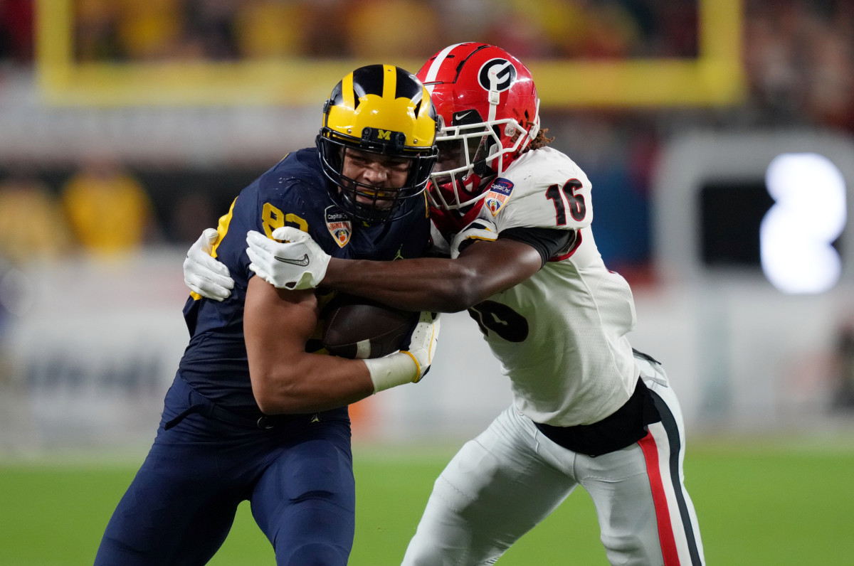 Dec 31, 2021; Miami Gardens, FL, USA; Michigan Wolverines tight end Erick All (83) is brought down by Georgia Bulldogs defensive back Lewis Cine (16) during the second quarter in the Orange Bowl college football CFP national semifinal game at Hard Rock Stadium. Mandatory Credit: Jasen Vinlove-USA TODAY Sports