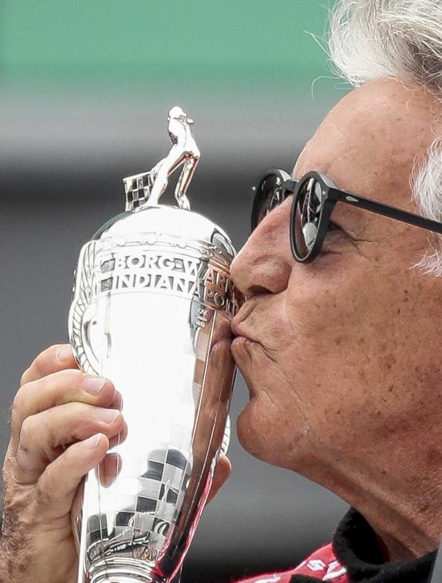 IndyCar legend Mario Andretti kisses a "Baby Borg", a replica of the trophy he won for winning the 1969 Indianapolis 500. Photo: Scott Utterback/For IndyStar-Imagn Content Services, LLC