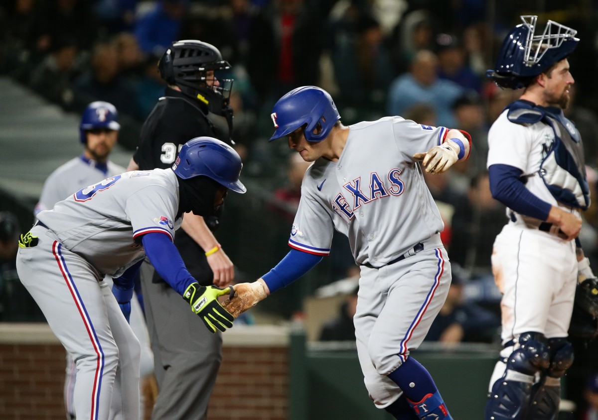 Apr 21, 2022; Seattle, Washington, USA; Texas Rangers right fielder Adolis Garcia (53) greets left fielder Nick Solak (15) after Solak hit a two-run home run against the Seattle Mariners during the fifth inning at T-Mobile Park. Mandatory Credit: Lindsey Wasson-USA TODAY Sports