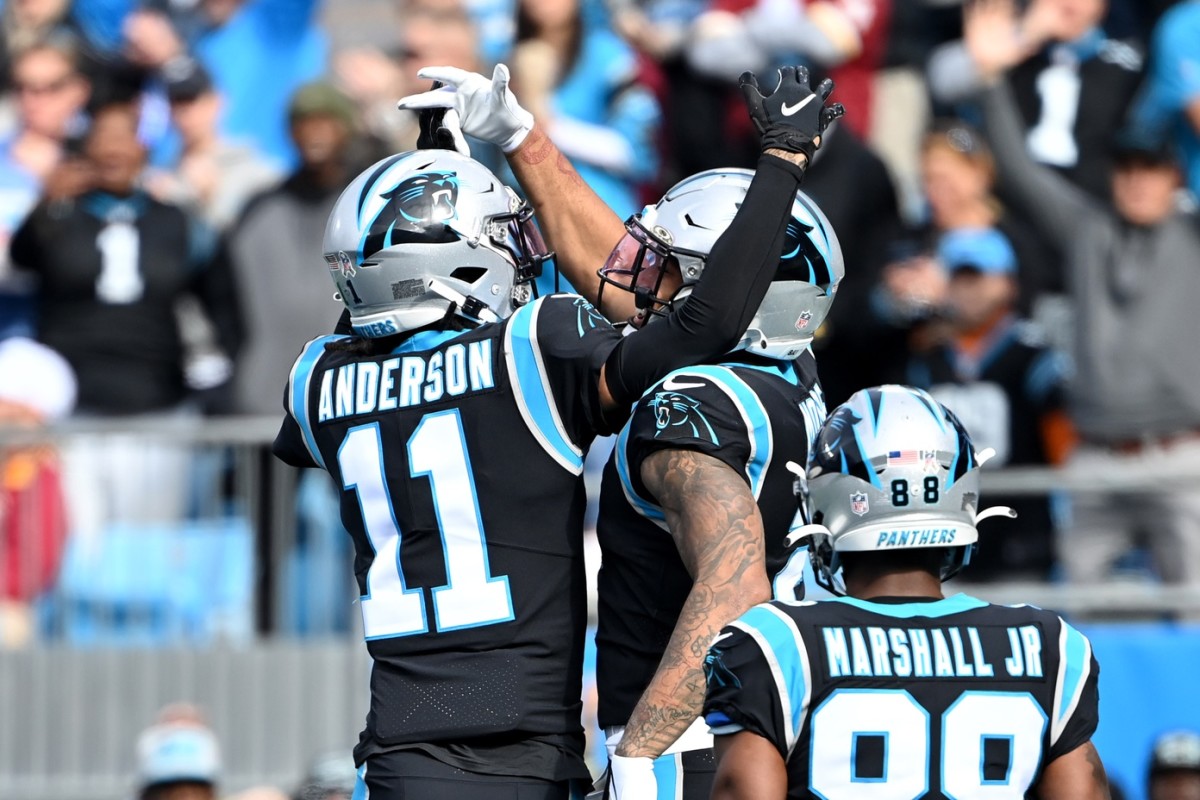 Carolina Panthers wide receiver D.J. Moore (2) celebrates with wide receivers Robby Anderson (11) and Terrace Marshall Jr. (88) after scoring a touchdown in the first quarter at Bank of America Stadium.
