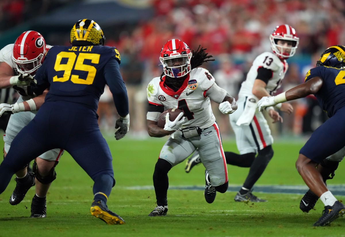 Dec 31, 2021; Miami Gardens, FL, USA; Georgia Bulldogs running back James Cook (4) runs the ball against the Michigan Wolverines during the third quarter in the Orange Bowl college football CFP national semifinal game at Hard Rock Stadium. Mandatory Credit: Jasen Vinlove-USA TODAY Sports