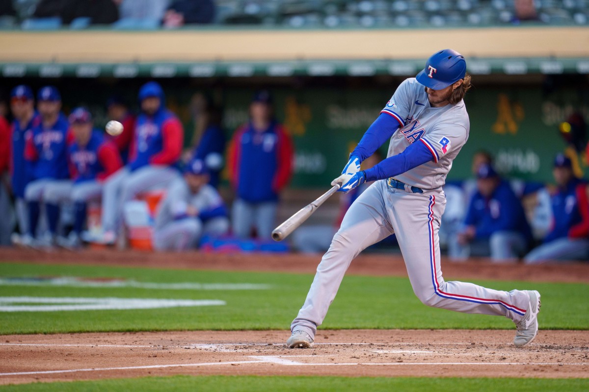 Apr 22, 2022; Oakland, California, USA; Texas Rangers catcher Jonah Heim (28) hits a double during the second inning against the Oakland Athletics at RingCentral Coliseum. Mandatory Credit: Neville E. Guard-USA TODAY Sports