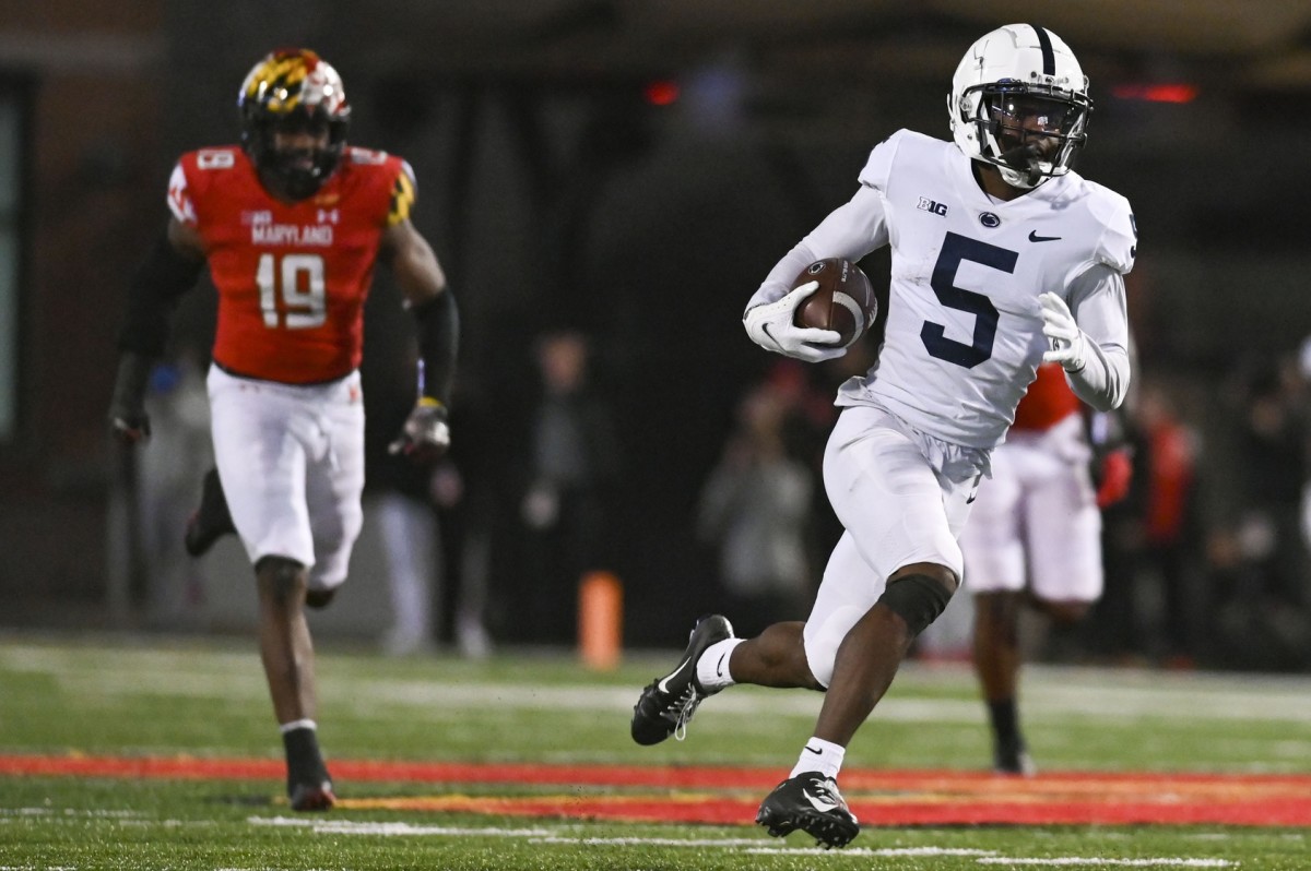 Nov 6, 2021; College Park, Maryland, USA; Penn State Nittany Lions wide receiver Jahan Dotson (5) runs a fourth quarter touchdown as Maryland Terrapins linebacker Ahmad McCullough (19) defends at Capital One Field at Maryland Stadium.