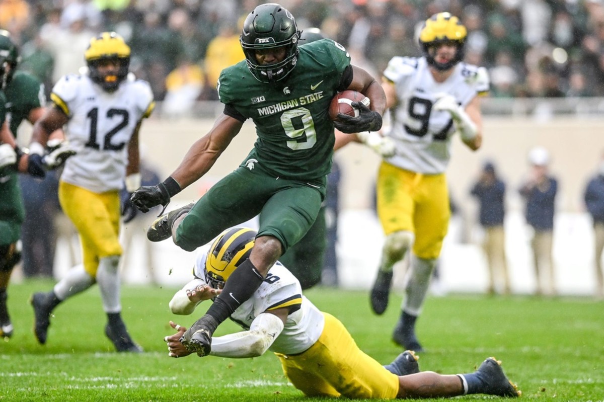 Michigan State's Kenneth Walker III avoids a tackle by Michigan's R.J. Moten during a touchdown run. Nick King/USA TODAY NETWORK / USA TODAY NETWORK