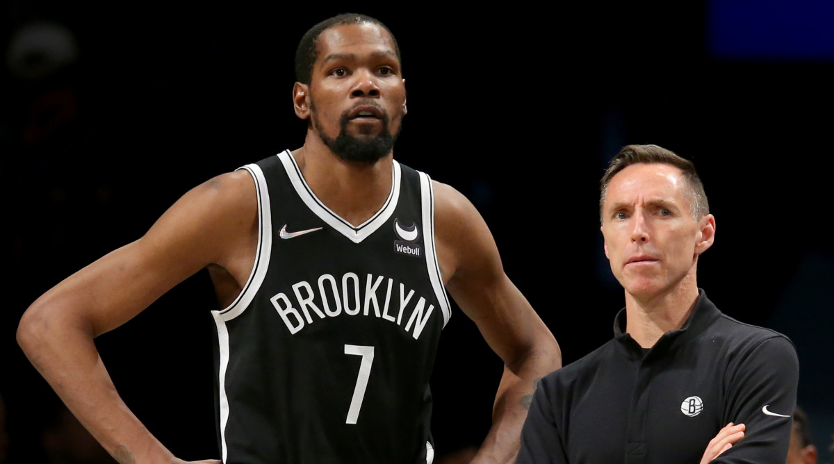 Brooklyn Nets head coach Steve Nash and forward Kevin Durant (7) watch during the fourth quarter against the Detroit Pistons at Barclays Center. The Nets defeated the Pistons 130-123.