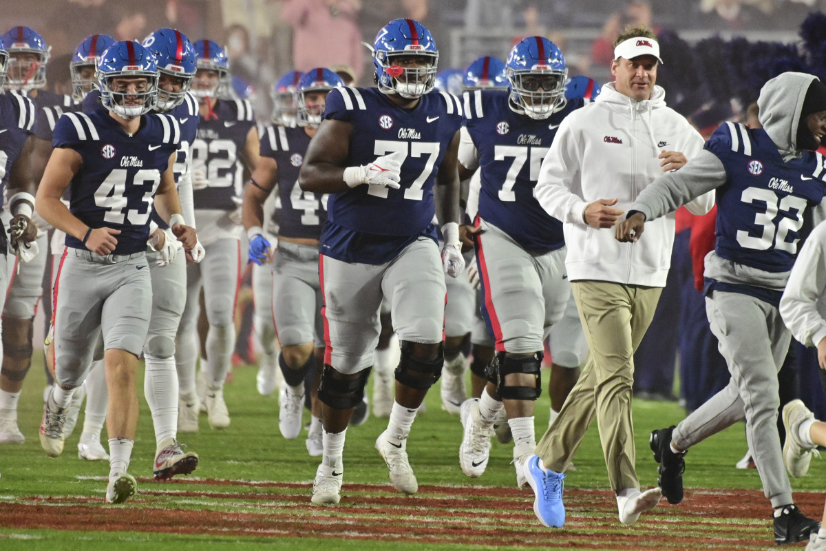 Nov 20, 2021; Oxford, Mississippi, USA; Mississippi Rebels head coach Lane Kiffin loses a shoe as he leads his team onto the field before the game against the Vanderbilt Commodores at Vaught-Hemingway Stadium. Mandatory Credit: Matt Bush-USA TODAY Sports