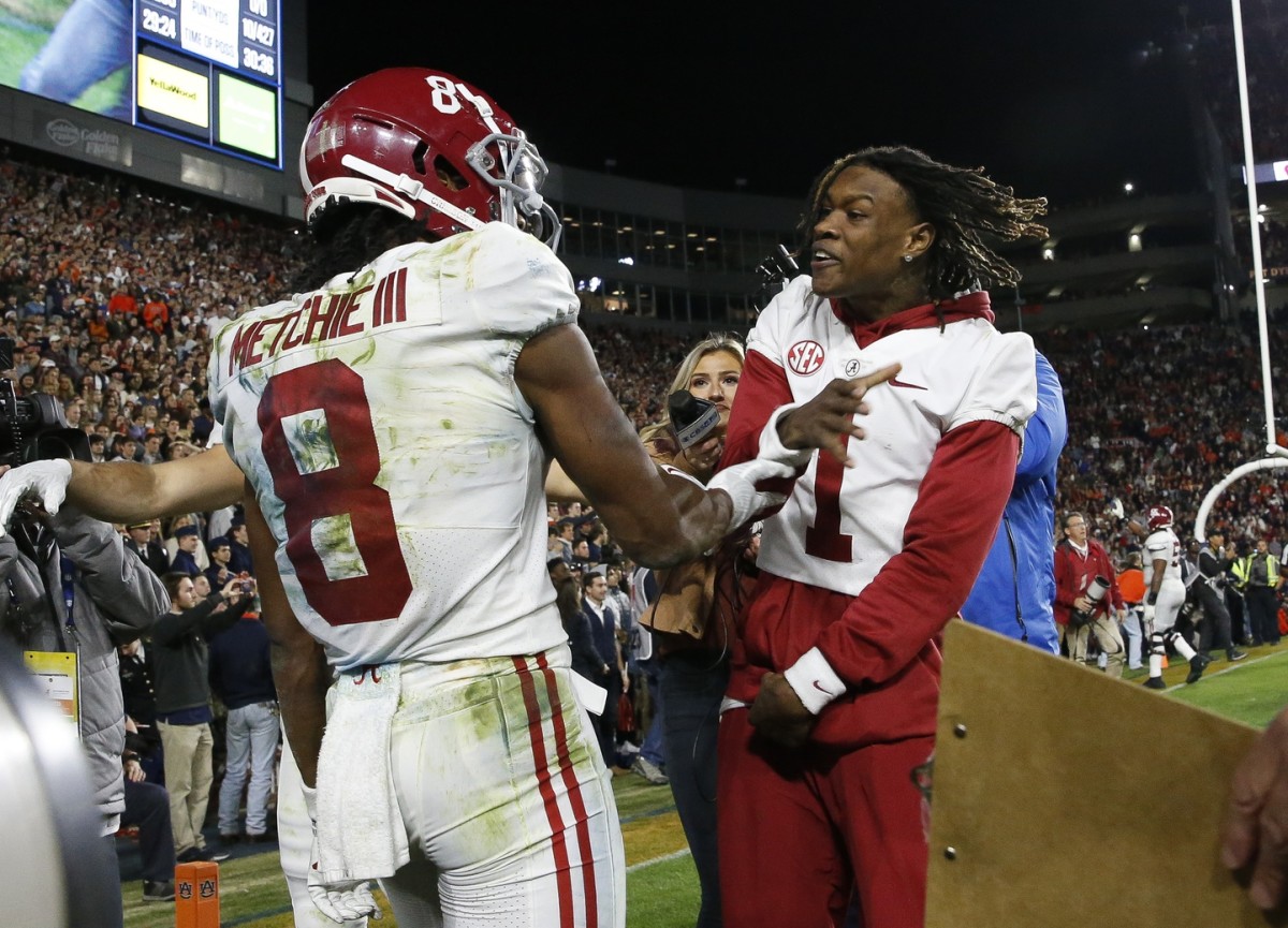 Nov 27, 2021; Auburn, Alabama, USA; Alabama Crimson Tide wide receiver John Metchie III (8) celebrates with wide receiver Jameson Williams (1) after catching the game-winning touchdown pass against the Auburn Tigers at Jordan-Hare Stadium. Alabama defeated Auburn in four overtimes.