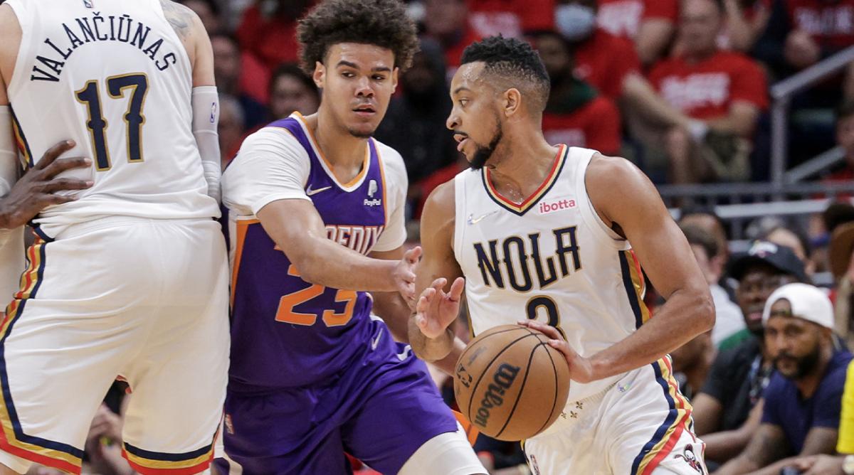 Apr 24, 2022; New Orleans, Louisiana, USA; New Orleans Pelicans guard CJ McCollum (3) dribbles against Phoenix Suns forward Cameron Johnson (23) during the first half of game four of the first round of the 2022 NBA playoffs at Smoothie King Center.