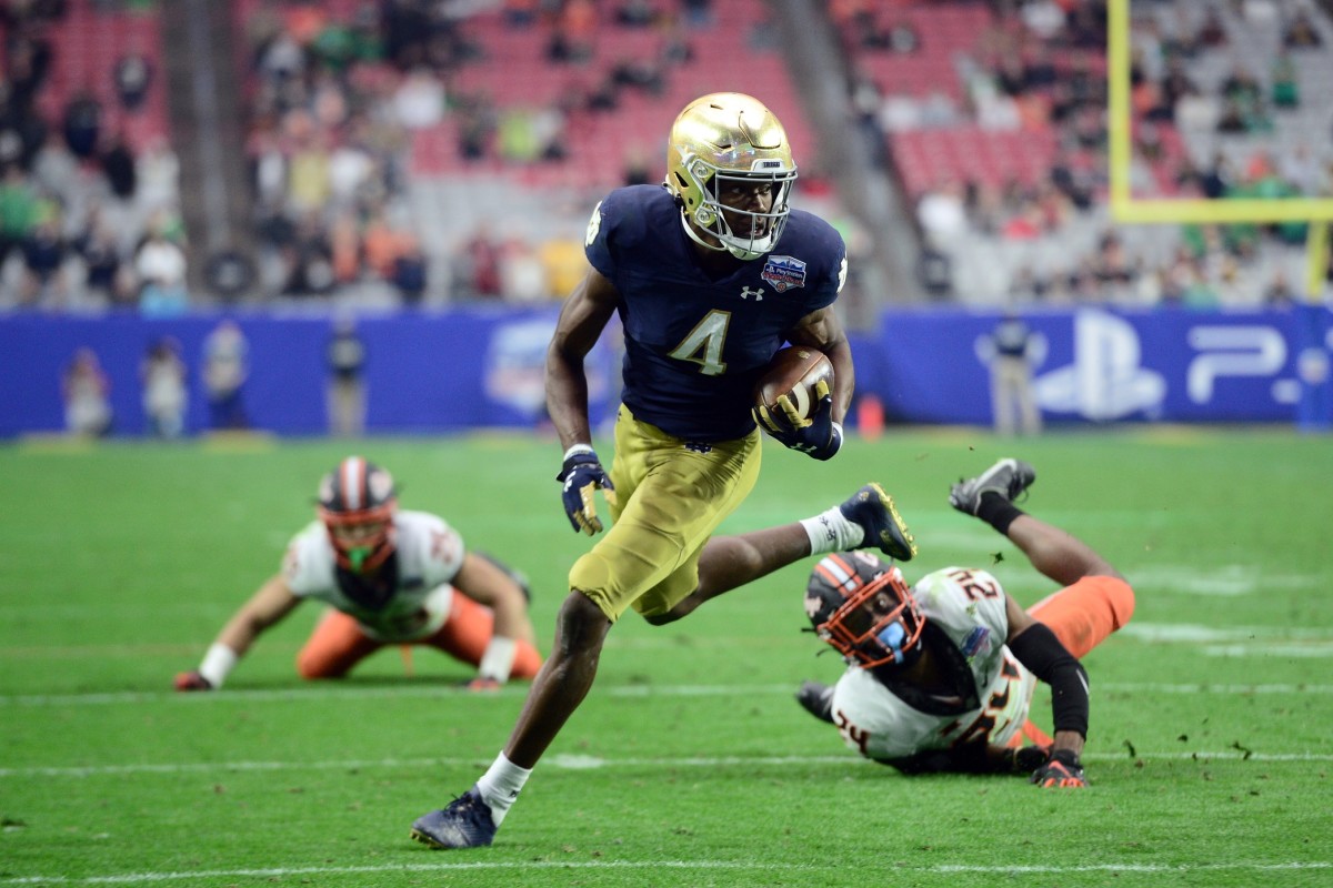 Notre Dame Fighting Irish wide receiver Kevin Austin Jr. (4) scores a touchdown against the Oklahoma State Cowboys during the second half of the 2022 Fiesta Bowl at State Farm Stadium.