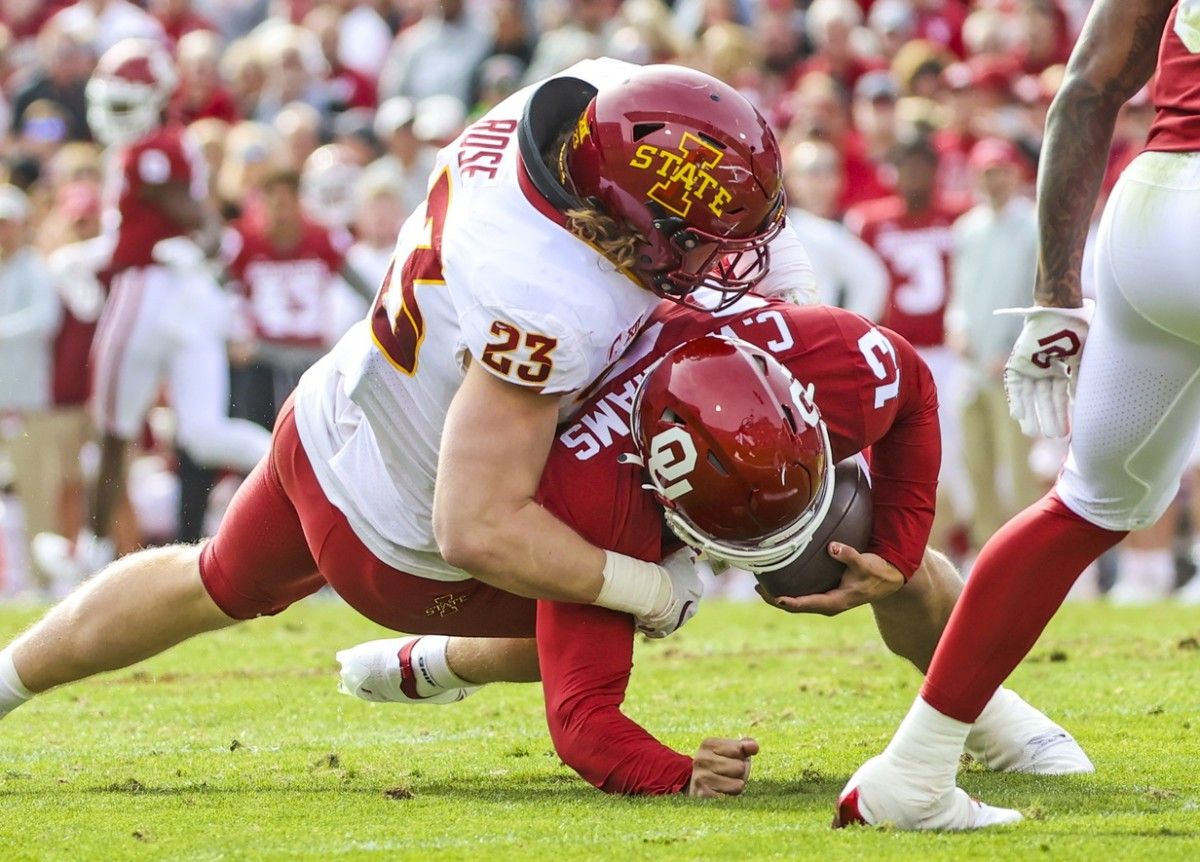 Iowa State Cyclones linebacker Mike Rose (23) tackles Oklahoma Sooners quarterback Caleb Williams (13) during the second half at Gaylord Family-Oklahoma Memorial Stadium.
