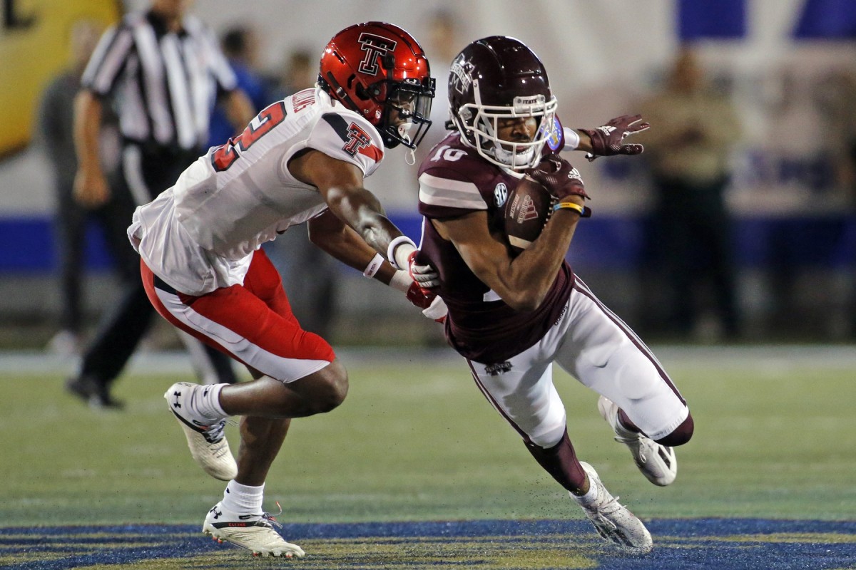 Dec 28, 2021; Memphis, TN, USA; Mississippi State Bulldogs wide receiver Makai Polk (10) runs the ball after a catch for a first down as Texas Tech Red Raiders defensive back Rayshad Williams (12) attempts to make the tackle during the first half at Liberty Bowl Stadium. Mandatory Credit: Petre Thomas-USA TODAY Sports
