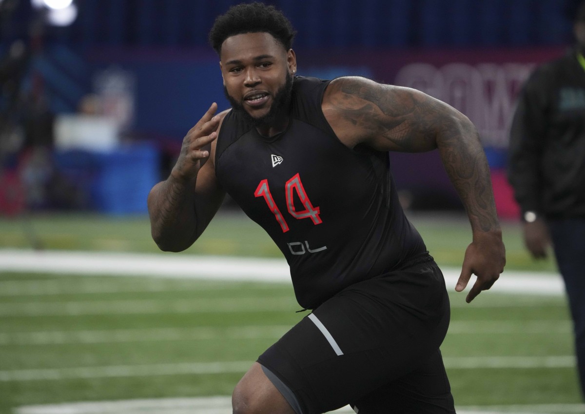 Mar 5, 2022; Indianapolis, IN, USA; Connecticut defensive lineman Travis Jones (DL14) goes through drills during the 2022 NFL Scouting Combine at Lucas Oil Stadium. Mandatory Credit: Kirby Lee-USA TODAY Sports
