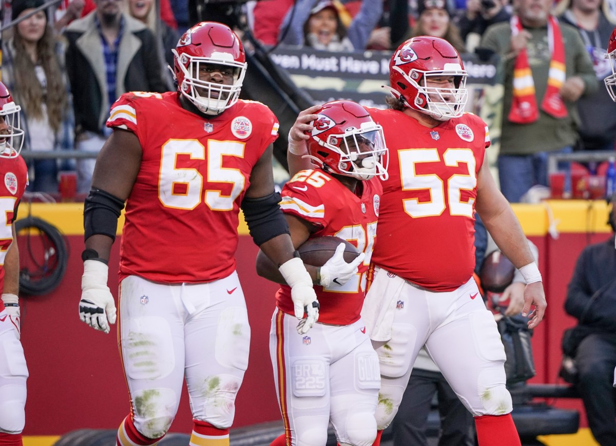 Nov 21, 2021; Kansas City, Missouri, USA; Kansas City Chiefs running back Clyde Edwards-Helaire (25) celebrates with guard Trey Smith (65) and center Creed Humphrey (52) after scoring against the Dallas Cowboys during the first half at GEHA Field at Arrowhead Stadium. Mandatory Credit: Denny Medley-USA TODAY Sports