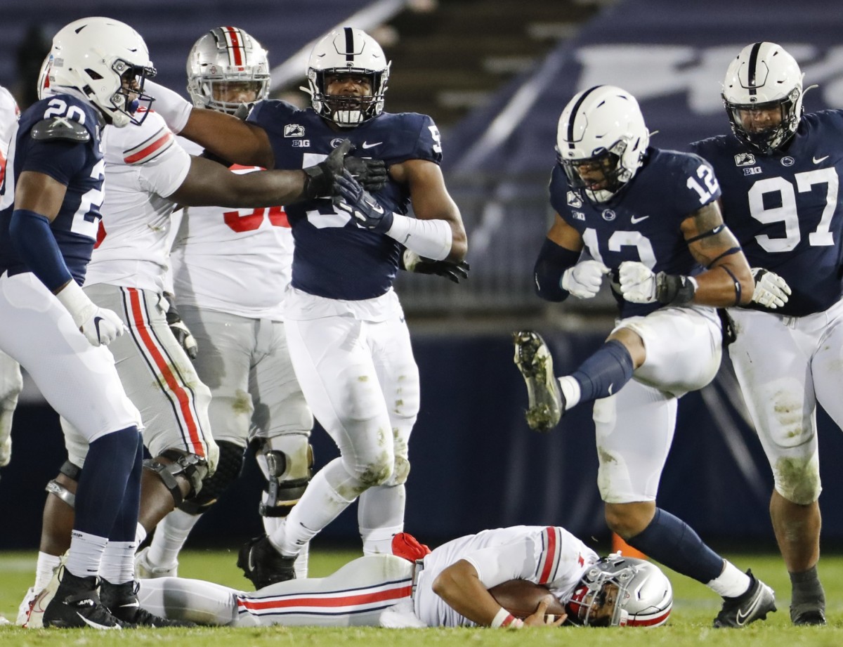 Oct 31, 2020; University Park, PA, USA; Penn State Nittany Lions linebacker Brandon Smith (12) celebrates after sacking Ohio State Buckeyes quarterback Justin Fields (1) during the fourth quarter of a NCAA football game at Beaver Stadium in University Park, Pa. on Saturday, Oct. 31, 2020. Mandatory Credit: Adam Cairns/Columbus Dispatch-USA TODAY NETWORK