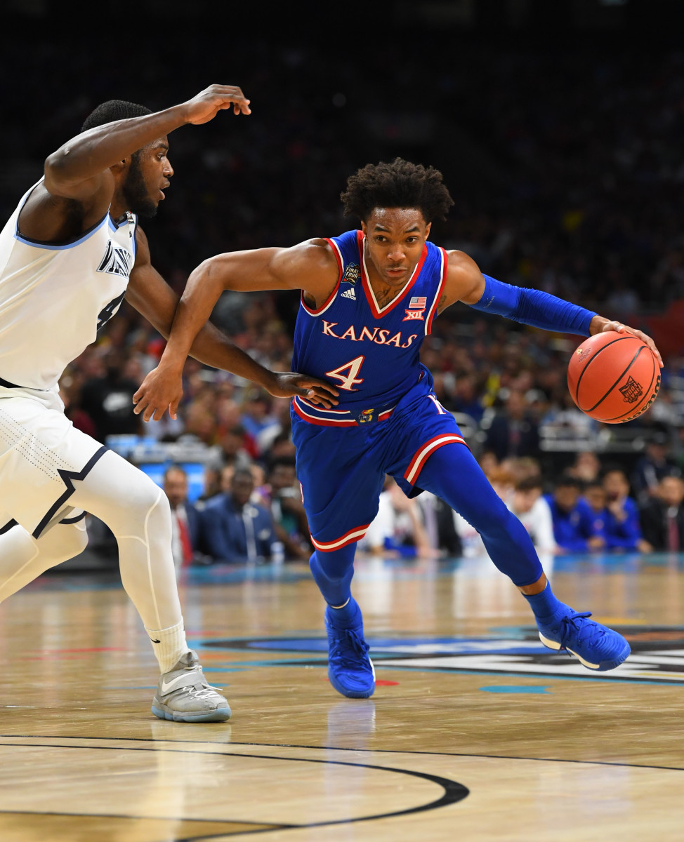 Mar 31, 2018; San Antonio, TX, United States; Kansas Jayhawks guard Devonte' Graham (4) drives to the basket defended by Villanova Wildcats forward Eric Paschall (4) during the first half in the semifinals of the 2018 men's Final Four at Alamodome. Mandatory Credit: Robert Deutsch-USA TODAY Sports