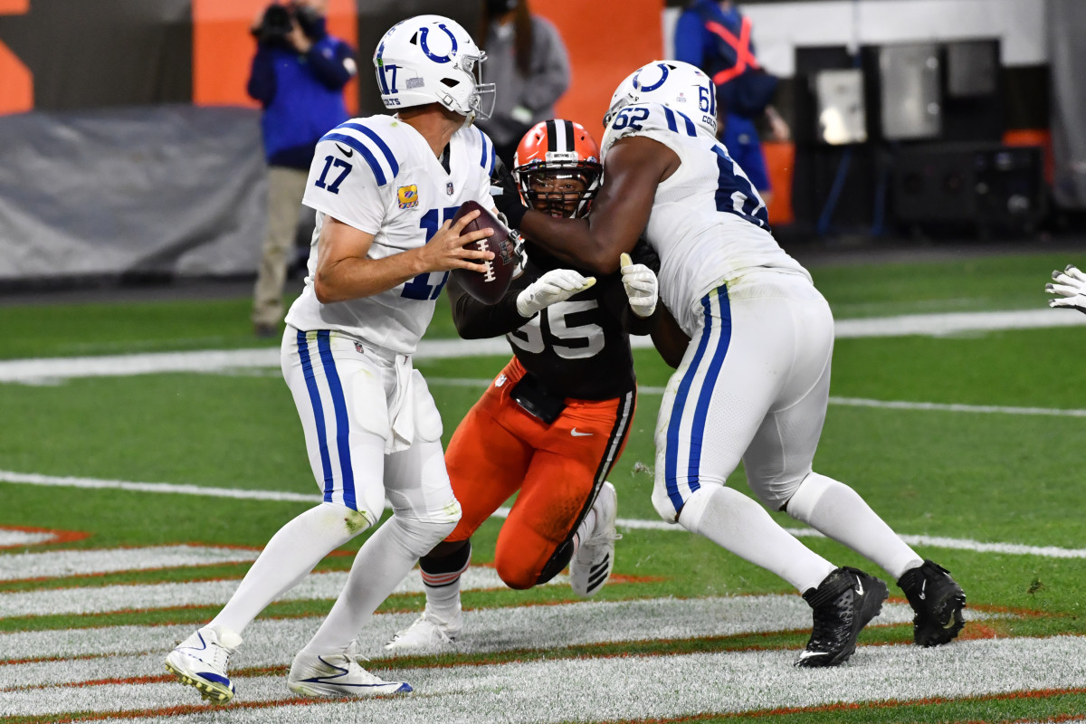 Oct 11, 2020; Cleveland, Ohio, USA; Cleveland Browns defensive end Myles Garrett (95) is blocked by Indianapolis Colts offensive tackle Le'Raven Clark (62) as quarterback Philip Rivers (17) drops back to pass during the second half at FirstEnergy Stadium. Garrett caused Rivers to throw the ball away resulting in a safety.