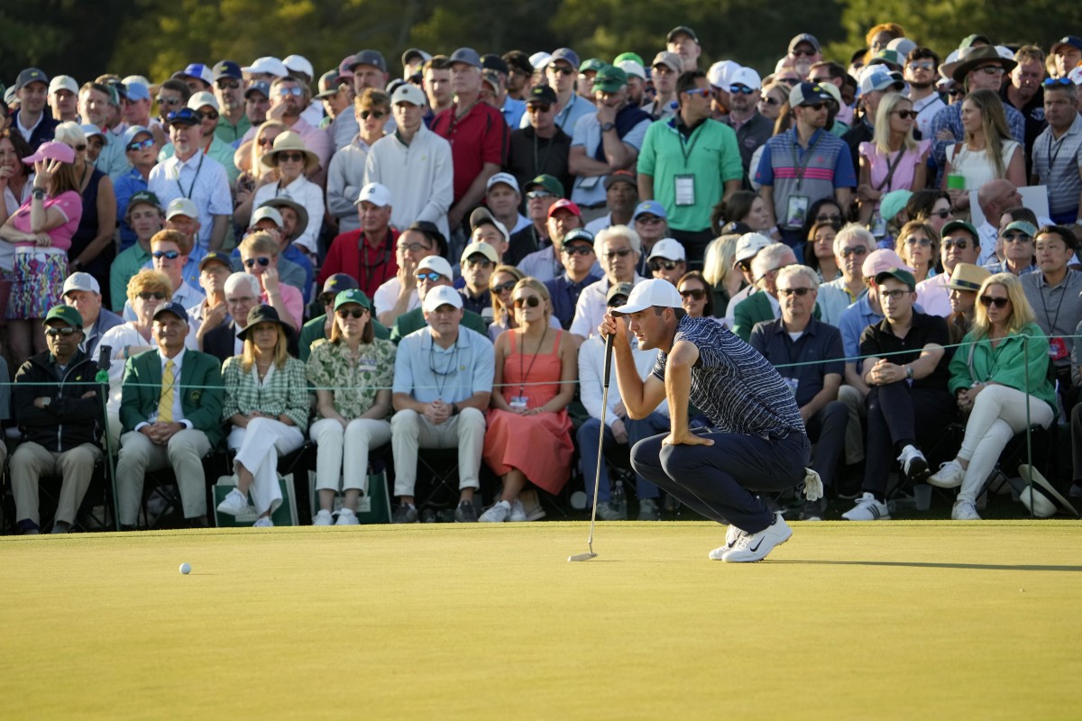 Apr 10, 2022; Augusta, Georgia, USA; Scottie Scheffler lines up his putt on no. 18 during the final round of the Masters Tournament at Augusta National Golf Club. Mandatory Credit: Adam Cairns-Augusta Chronicle/USA TODAY Sports