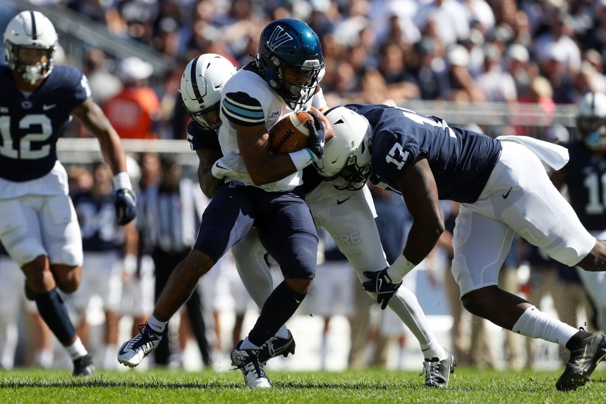 Sep 25, 2021; University Park, Pennsylvania, USA; Villanova Wildcats wide receiver Dez Boykin (10) runs with the ball as Penn State Nittany Lions cornerback Daequan Hardy (25) and defensive end Arnold Ebiketie (17) attempt a tackle during the first quarter at Beaver Stadium. Mandatory Credit: Matthew OHaren-USA TODAY Sports