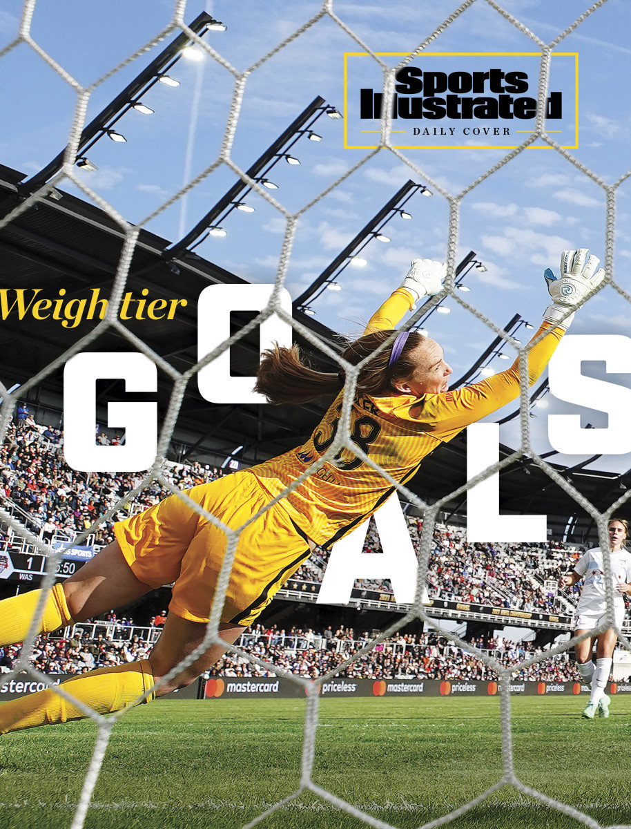 Chicago Red Stars goalkeeper Cassie Miller lets a soccer ball in the net