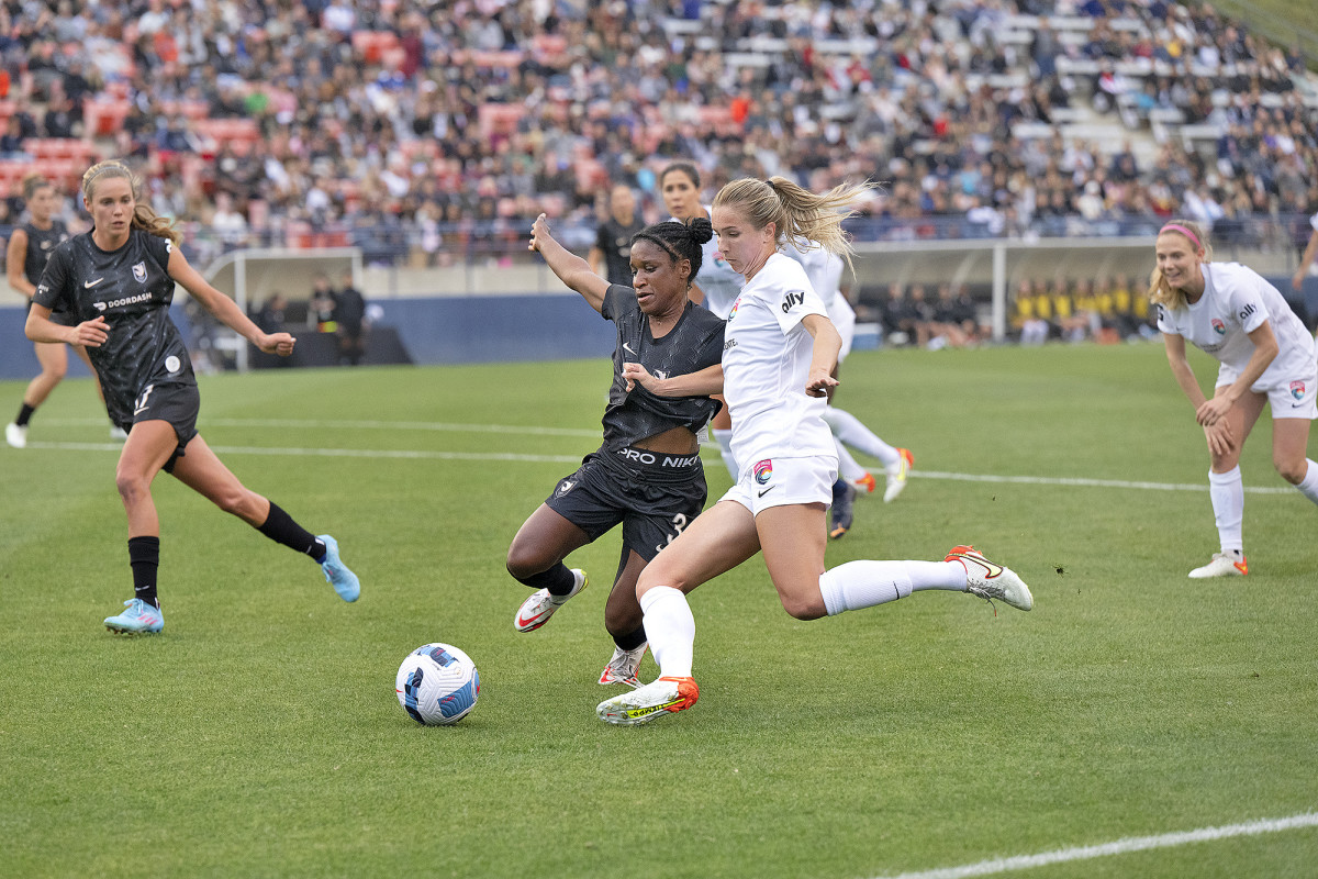 Members of the San Diego Wave and Angel City FC battle for the soccer ball