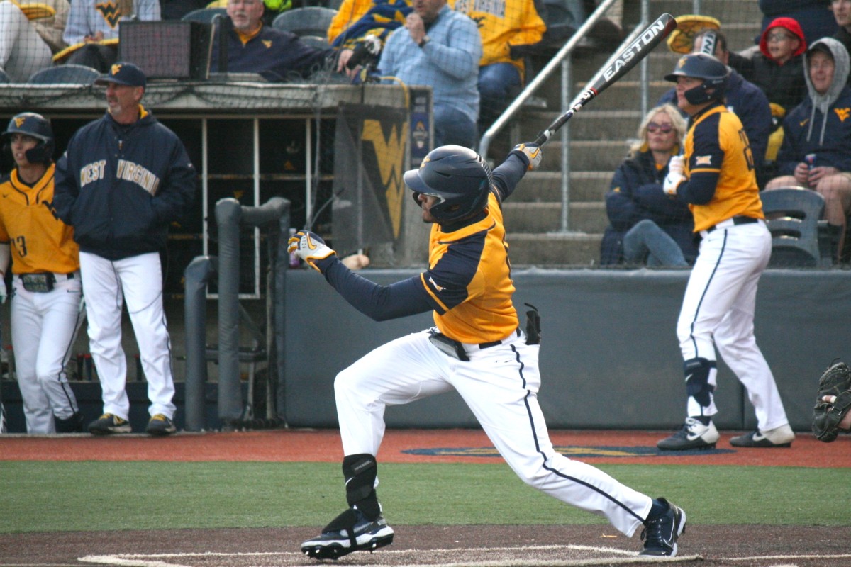 West Virginia's Victor Scott hitting a double against Penn State.