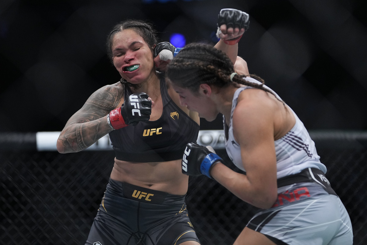 Julianna Peña (r.) moves in with a hit against Amanda Nunes during UFC 269 at T-Mobile Arena.