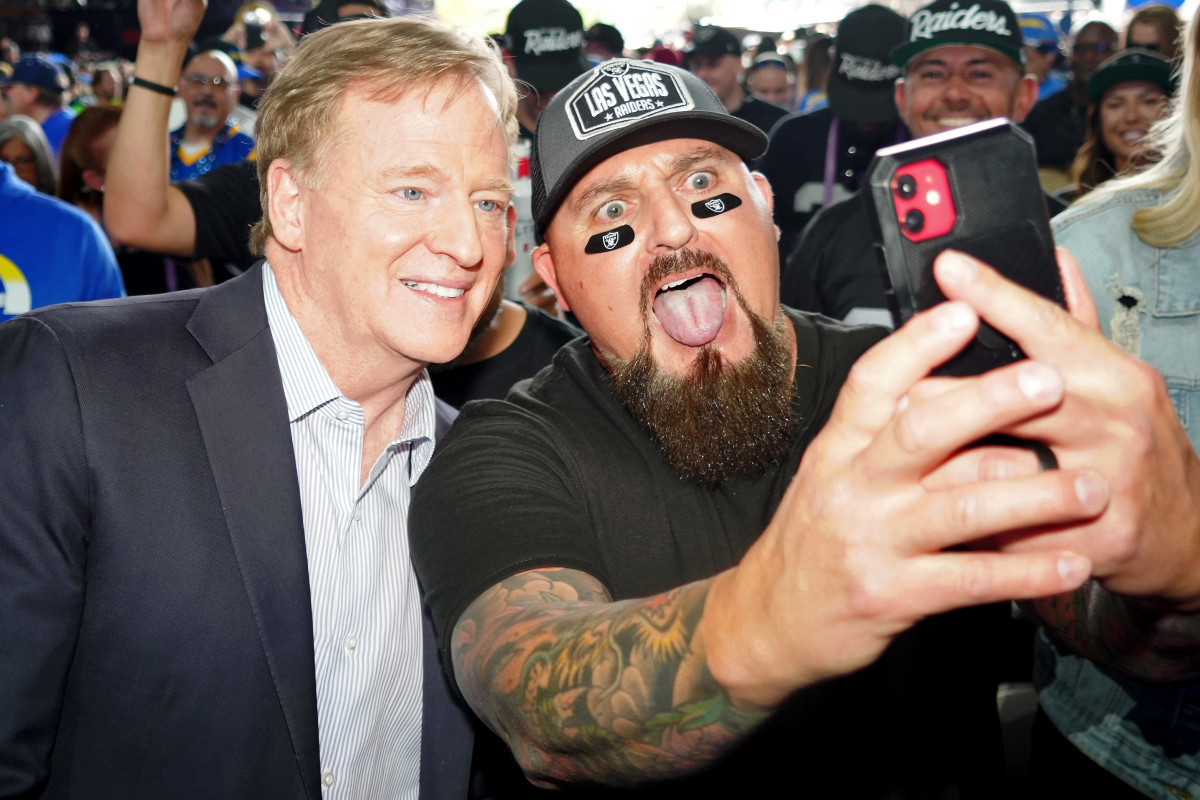 NFL commissioner Roger Goodell poses for a photo with a Las Vegas Raiders fan before the first round of the 2022 NFL Draft at the NFL Draft Theater.