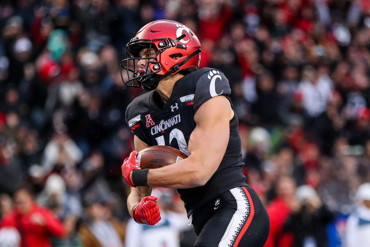 Nov 20, 2021; Cincinnati, Ohio, USA; Cincinnati Bearcats wide receiver Alec Pierce (12) reacts after scoring a touchdown against the Southern Methodist Mustangs in the first half at Nippert Stadium.