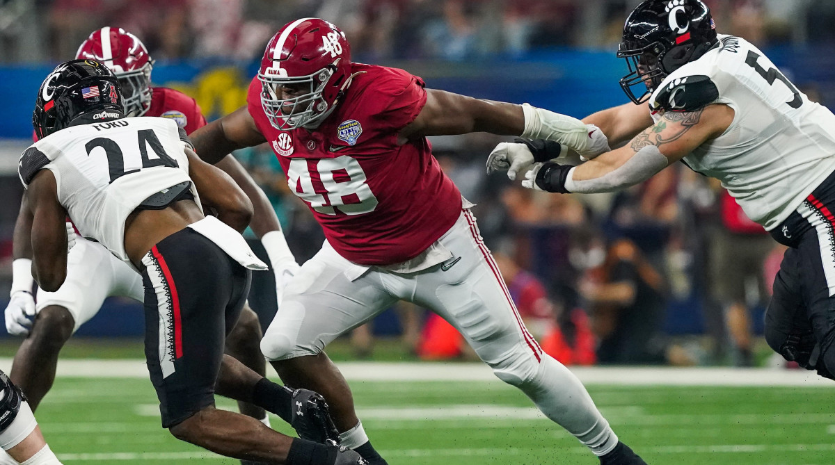 Alabama defensive lineman Phidarian Mathis (48) tackles Cincinnati running back Jerome Ford (24) in the 2021 College Football Playoff Semifinal game at the 86th Cotton Bowl in AT&T Stadium in Arlington, Texas Friday, Dec. 31, 2021.