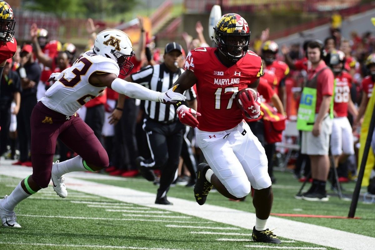 Maryland Terrapins tight end Chigoziem Okonkwo (17) runs pass Minnesota Golden Gophers defensive back Jordan Howden (23) during the fourth quarter at Capital One Field at Maryland Stadium.
