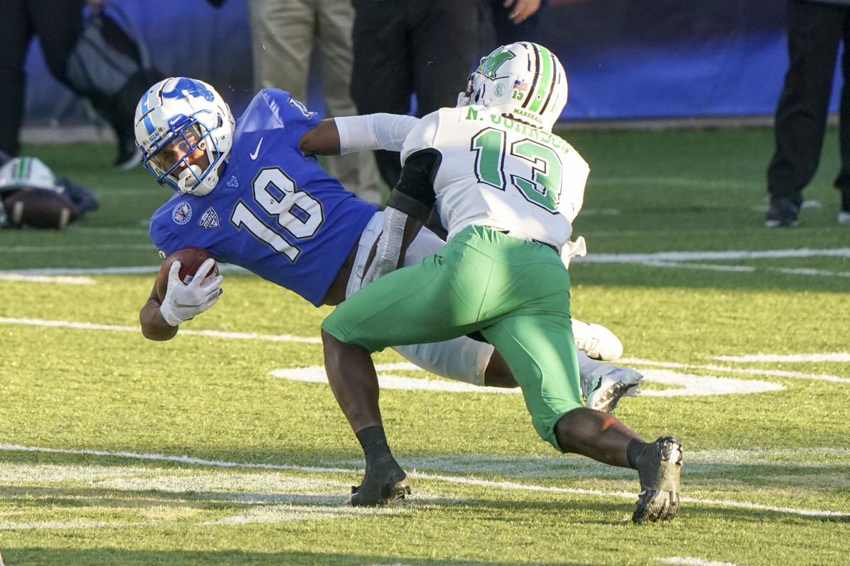 Dec 25, 2020; Montgomery, AL, USA; Buffalo Bulls wide receiver Trevor Wilson (18) is tackled by Marshall Thundering Herd safety Nazeeh Johnson (13) during the second half at Cramton Bowl Stadium. Mandatory Credit: Marvin Gentry-USA TODAY Sports
