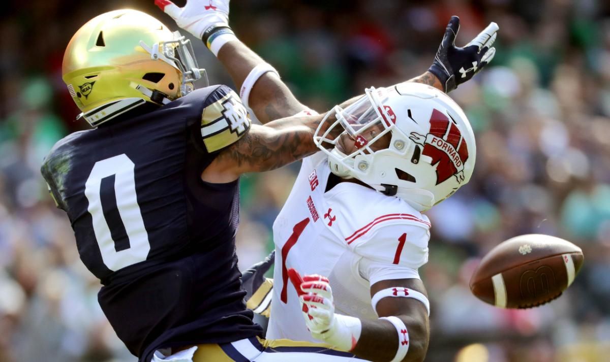 Wisconsin cornerback Faion Hicks (1) breaks up a pass intended for Notre Dame wide receiver Braden Lenzy (0) during the second quarter of their game Saturday, September 25, 2021 at Soldier Field in Chicago, Ill.
