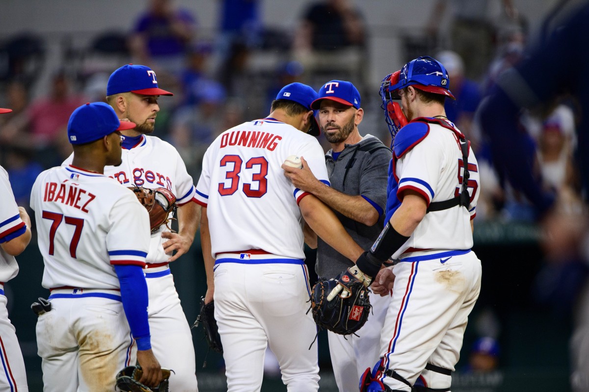 Apr 30, 2022; Arlington, Texas, USA; Texas Rangers manager Chris Woodward (8) pulls starting pitcher Dane Dunning (33) during the eighth inning against the Atlanta Braves at Globe Life Field. Mandatory Credit: Jerome Miron-USA TODAY Sports