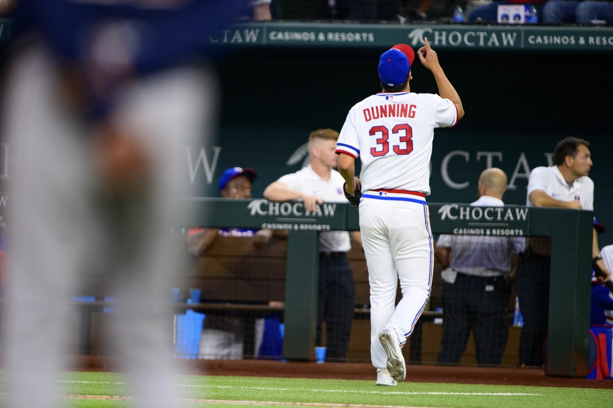 Apr 30, 2022; Arlington, Texas, USA; Texas Rangers starting pitcher Dane Dunning (33) motions to the sky as he leaves the game against the Atlanta Braves during the eighth inning at Globe Life Field.