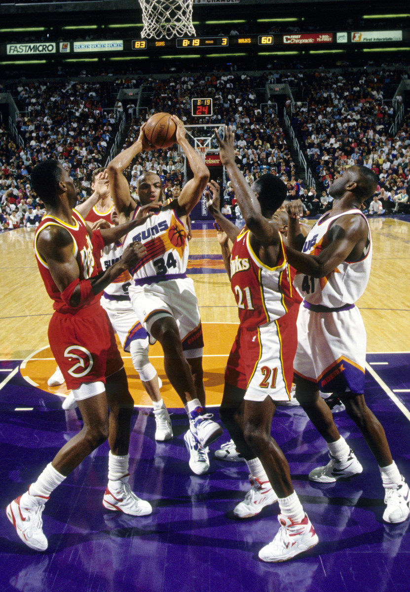 Feb 18, 1993; Phoenix, AZ, USA; FILE PHOTO; Phoenix Suns forward Charles Barkley (34) battles for a rebound between Atlanta Hawks forward Dominigue Wilkins (21) and Kevin Willis (42) at America West Arena.