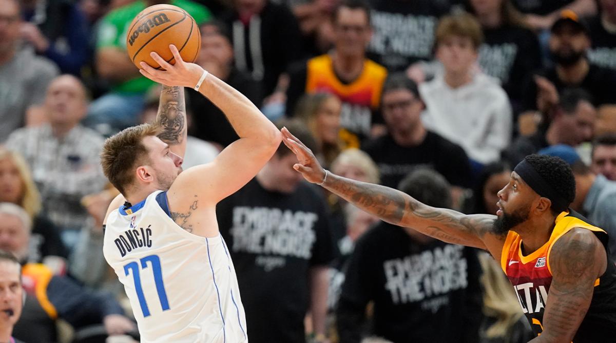 Dallas Mavericks guard Luka Doncic (77) shoots over Utah Jazz forward Royce O’Neale, right,half of Game 6 of an NBA basketball first-round playoff series Thursday, April 28, 2022, in Salt Lake City.