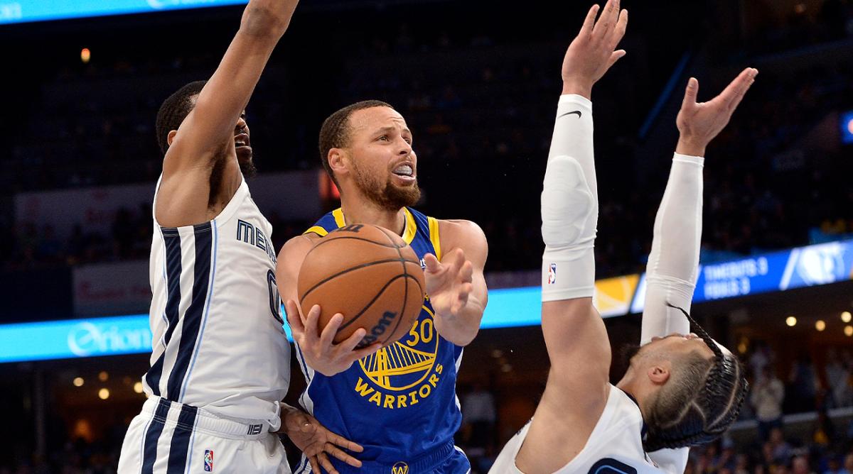 Golden State Warriors guard Stephen Curry (30) shoots against Memphis Grizzlies forward Dillon Brooks (24) and guard De’Anthony Melton (0) in the second half during Game 1 of a second-round NBA basketball playoff series Sunday, May 1, 2022, in Memphis, Tenn.
