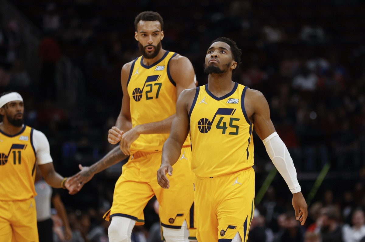 Utah Jazz guard Donovan Mitchell (45) and center Rudy Gobert (27) react after a play during the third quarter against the Houston Rockets at Toyota Center.