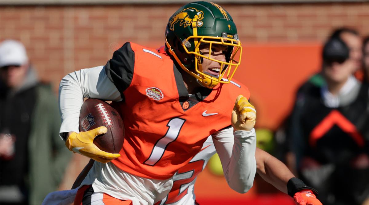 FILE - National Team wide receiver Christian Watson of North Dakota State (1) carries the ball after a reception over American Team cornerback Zyon McCollum of Sam Houston State (32) in the Senior Bowl NCAA college football game, Saturday, Feb. 5, 2022, in Mobile, Ala. Offensive lineman Trevor Penning of Northern Iowa and receiver Christian Watson of North Dakota State, two FCS schools, could be first-rounders in the NFL Draft.