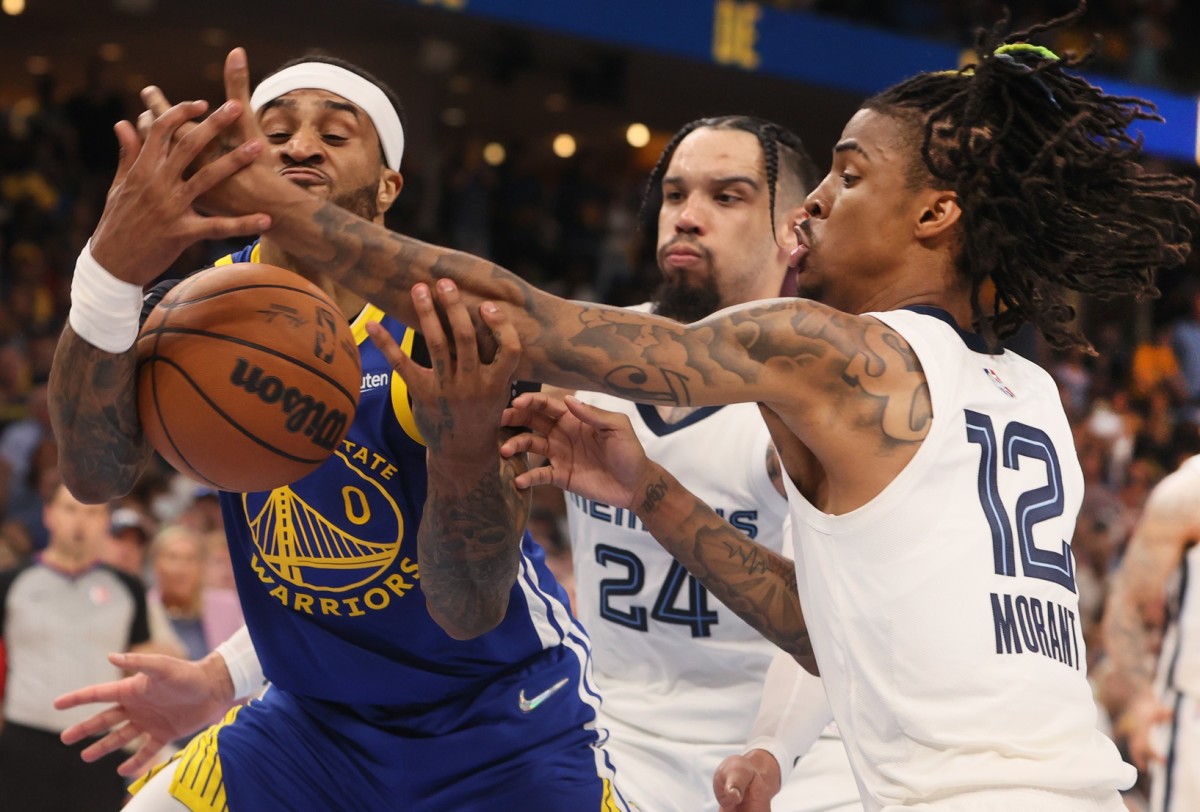 May 1, 2022; Memphis, Tennessee, USA; Memphis Grizzlies guard Ja Morant (12) fights for a rebound with Golden State Warriors guard Gary Payton II (0) during game one of the second round for the 2022 NBA playoffs at FedExForum. Mandatory Credit: Joe Rondone-USA TODAY Sports