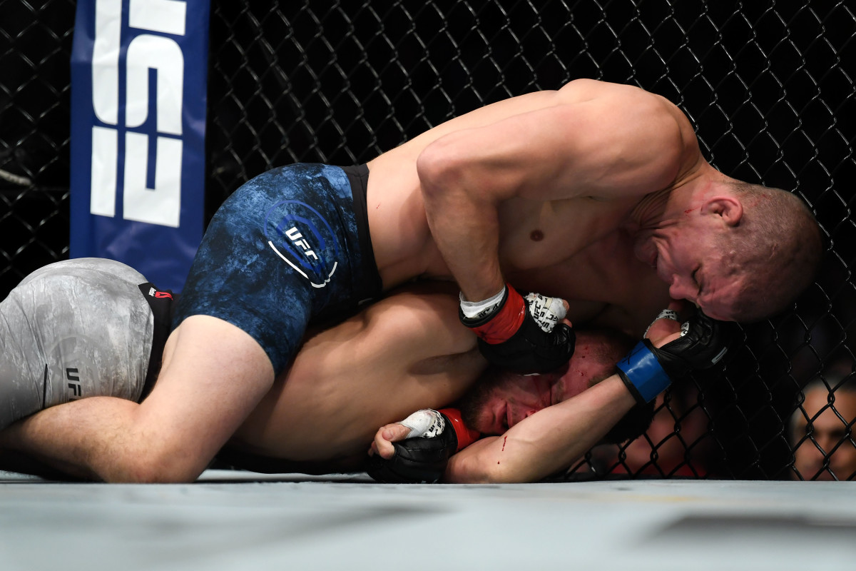Joe Lauzon (top) smashes Jonathan Pearce in a lightweight bout during UFC Fight Night in 2019.